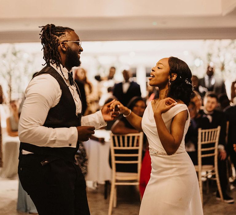 Bride & groom dance with one another on their wedding day during reception