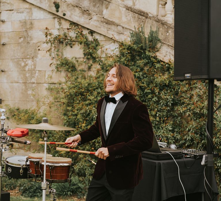 percussion wedding entertainer in a deep red velvet tuxedo jacket at Kirtlington Park 