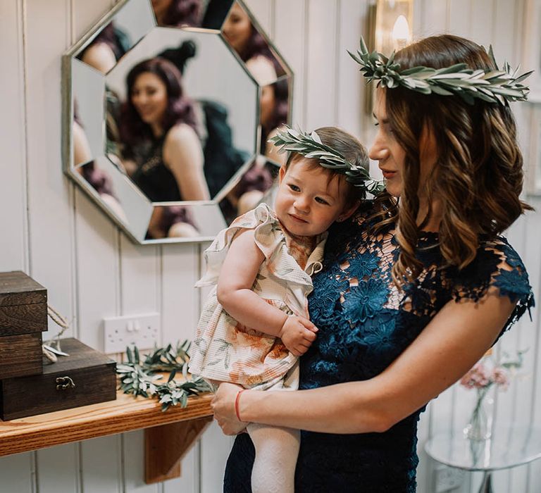 Wedding guest carries baby on wedding day