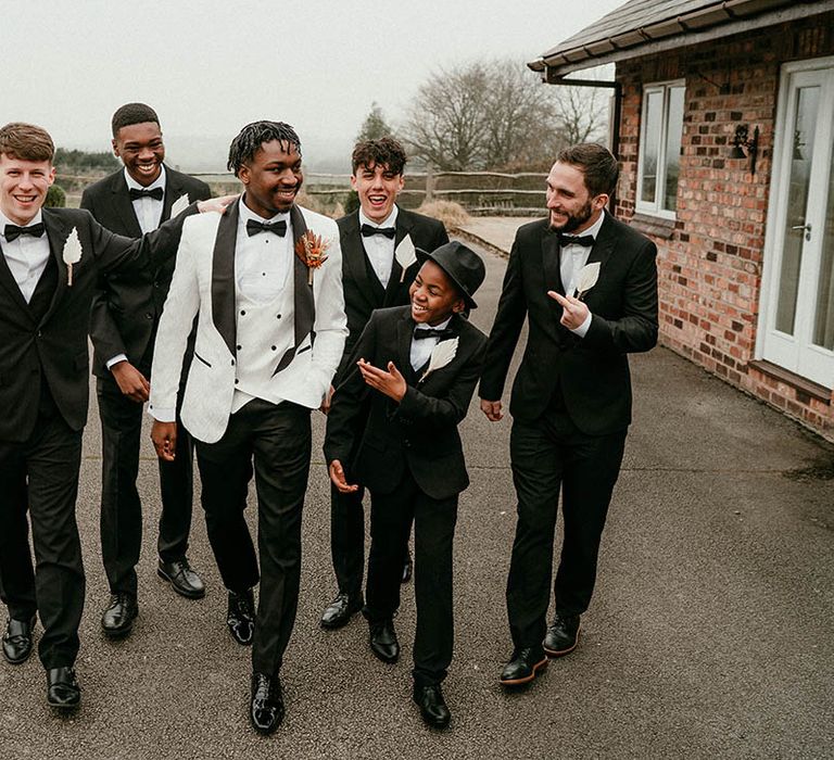 Groom with groomsmen in black tie