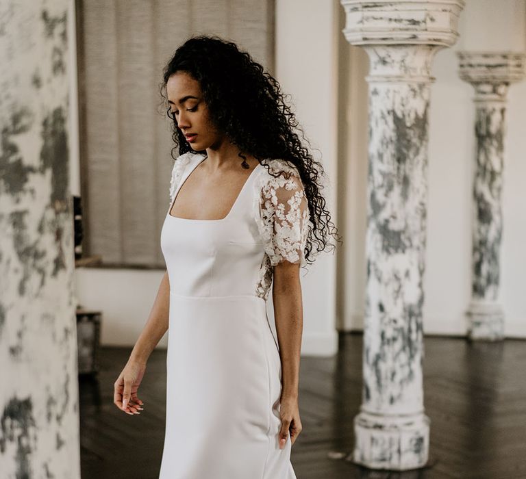 Black bride in an A-line wedding dress with square neckline and short lace sleeves 