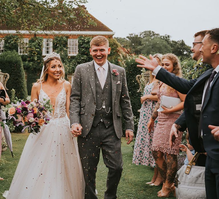 Bride and groom have their confetti exit