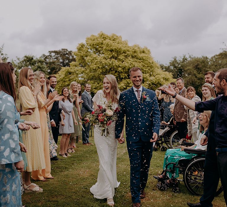 Confetti exit for bride and groom's rustic barn wedding