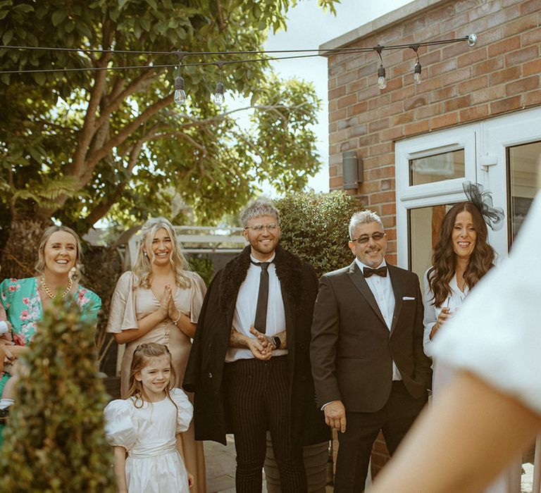 Wedding guests get their first look at the bride as she comes down all ready for her big day 