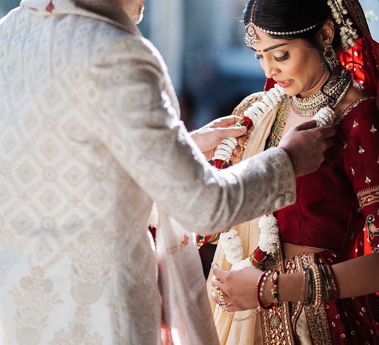 Groom places the Jaimala on the bride