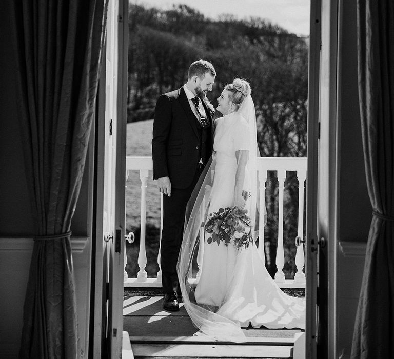 Bride and groom look lovingly into each other's eyes 