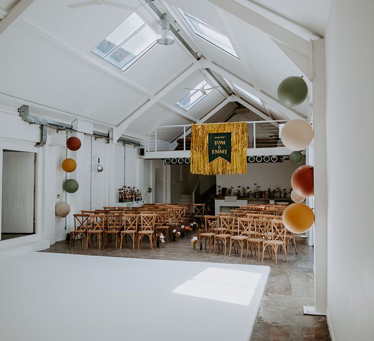 Gold streamer hangs from ceiling complete with velvet banner with personalised names