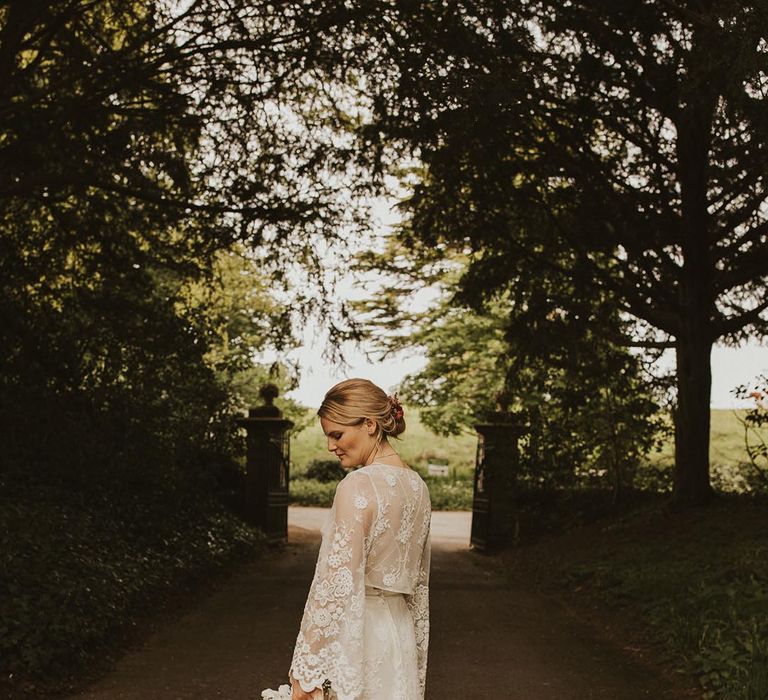 Bride in a boho wedding dress with a lace coverup 