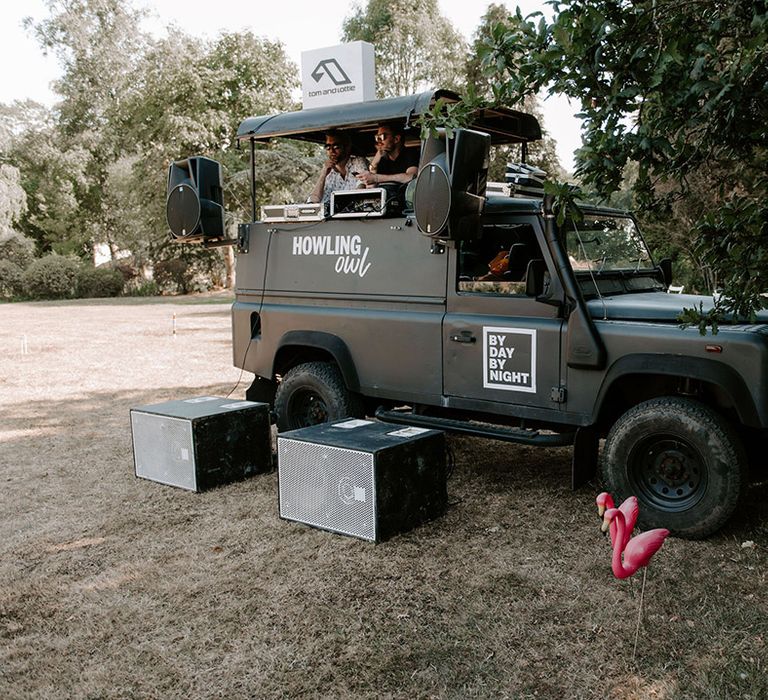 Outdoor black truck DJ booth on the lawn for the wedding 