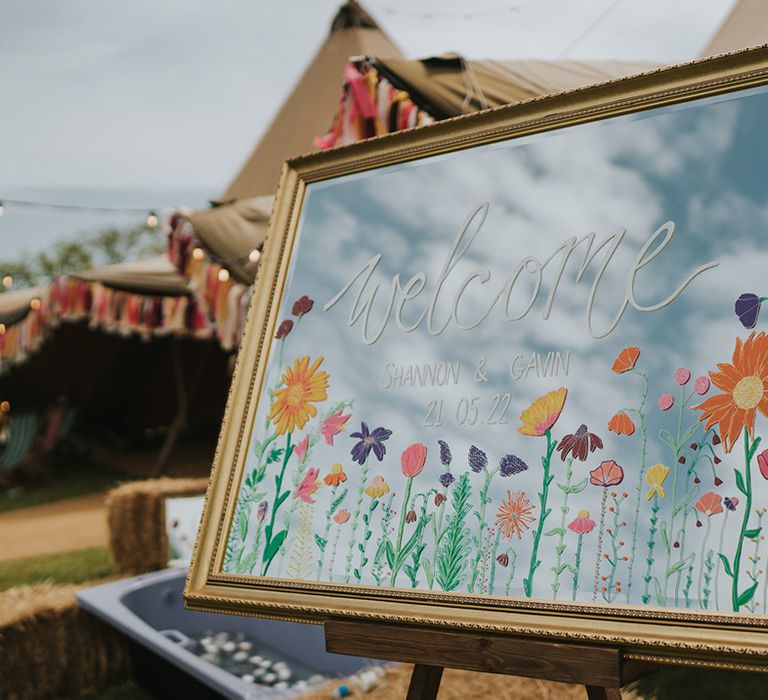 Gold mirror wedding sign with colourful floral illustration 