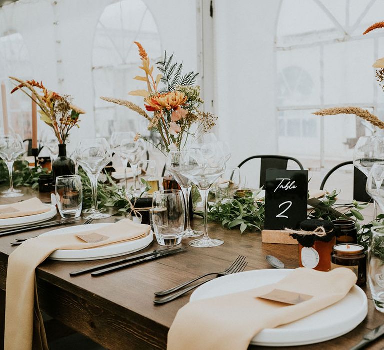 black wedding table decor and wildflowers at industrial and botanical wedding in France 