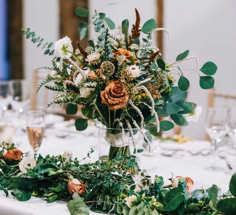 White tablecloth, foliage wedding table runners and pampas grass, eucalyptus, blush garden roses, dried flowers and foliage floral centrepieces 