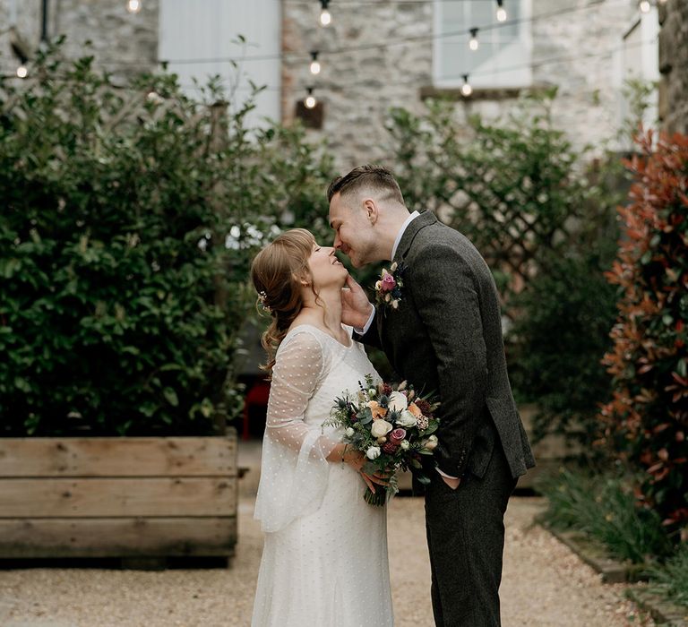 Holmes Mill industrial wedding with the bride and groom sharing a special kiss together 