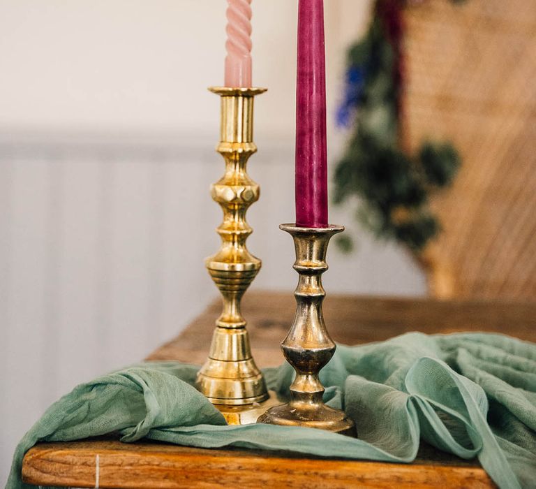 Pink candles decorate the wedding tablescape in gold candleholders 