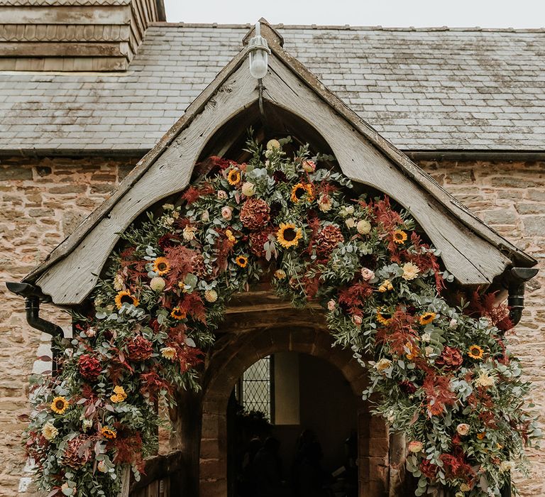 Sunflower wedding flower arch over church entrance for autumn wedding 