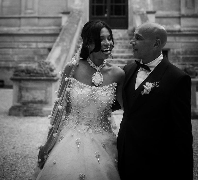 Bride in a sparkly strapless wedding dress with groom in navy and blue tux 