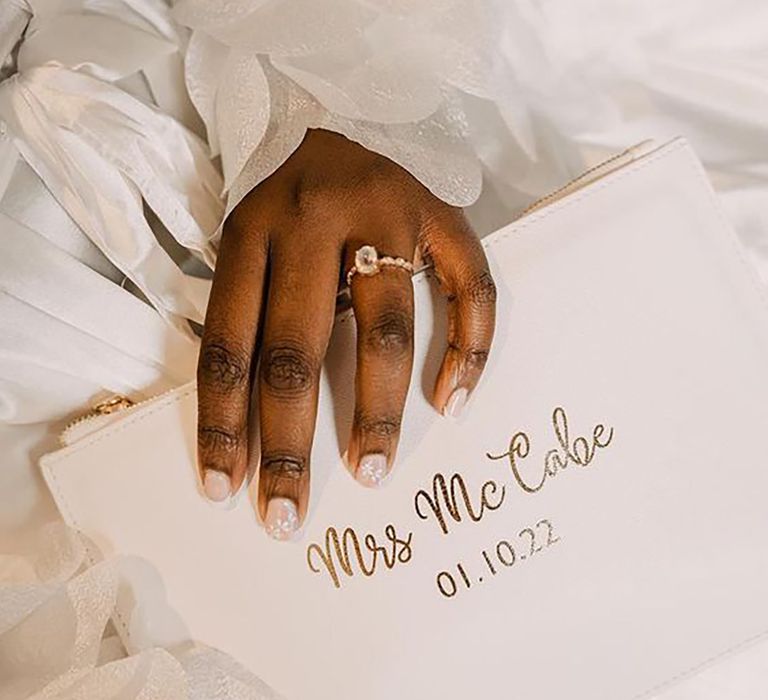 Bride holding a personalised bridal clutch by Kalie Reid Photography