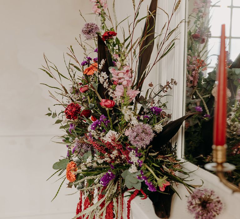 Colourful lilac and orange wedding flower decorations 