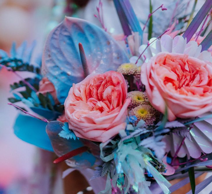 Bouquet with iridescent Anthuriums, roses and spray painted grasses  