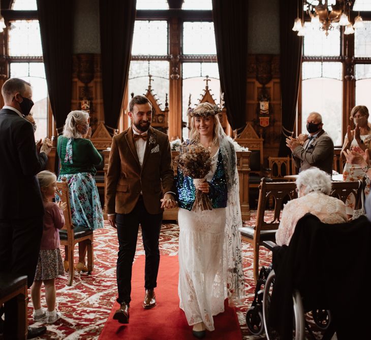 Bride and groom descending up the aisle as husband and wife