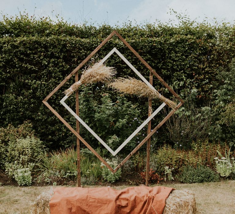 Geometric frame seating area at outdoor wedding reception 