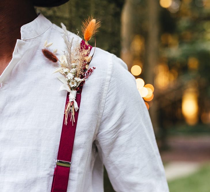 Red braces with floral buttonhole 