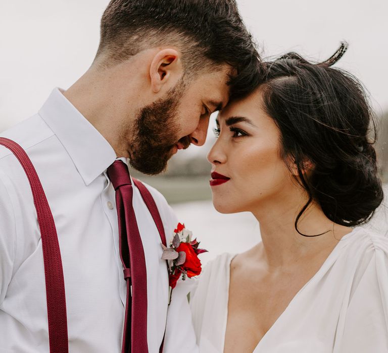 Bride and Groom in red and white by lake