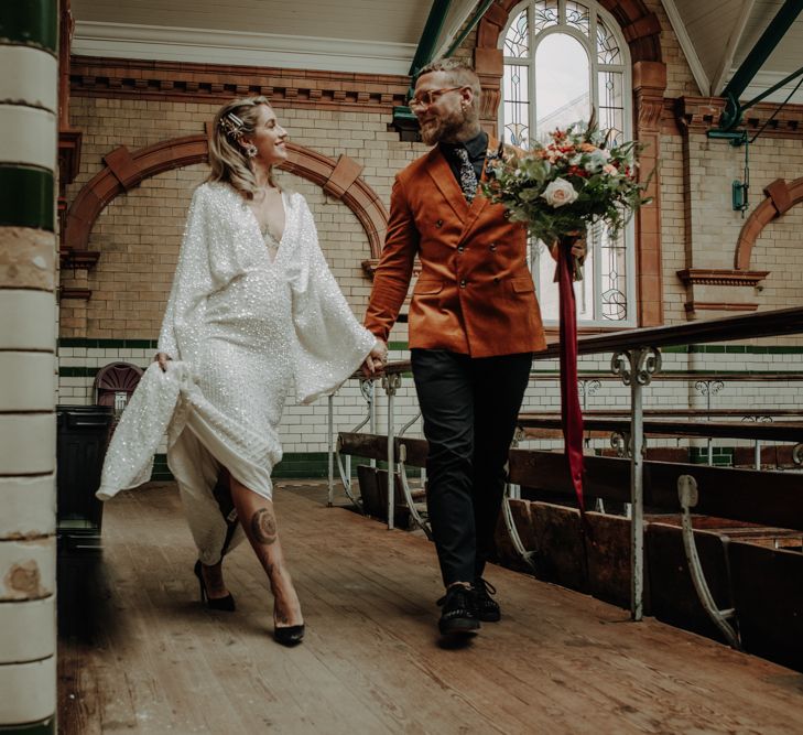 Couple walk through Victoria Baths