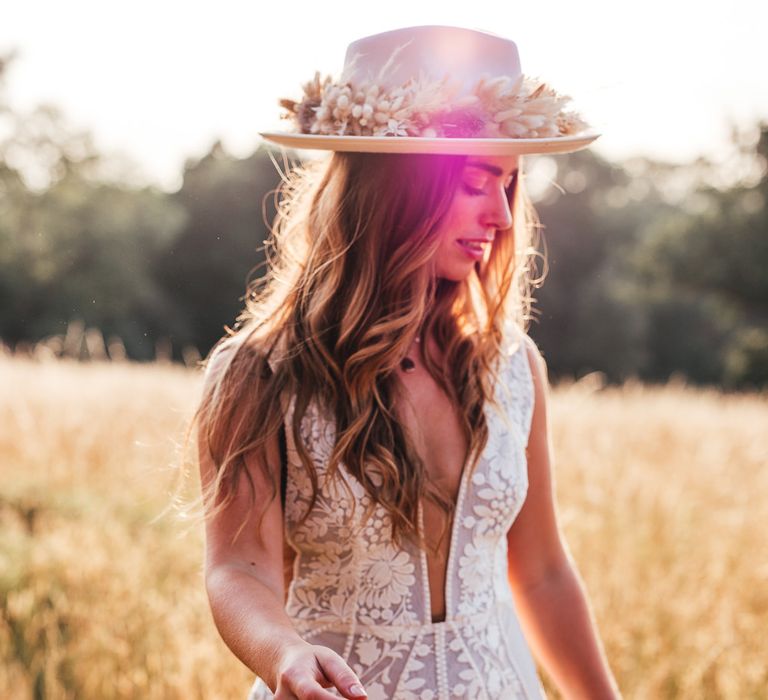 Bride walks through golden fields with blonde hair