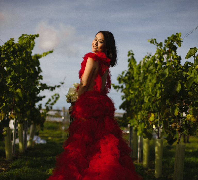 Dramatic ruffle skirt red wedding dress for an outdoor wedding venue