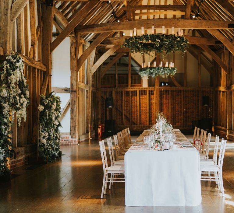 Micklefield Hall with large white table in a rustic setting surrounded by white florals