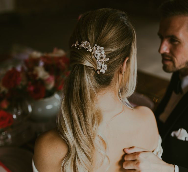 Bride wears her hair in sleek low ponytail 