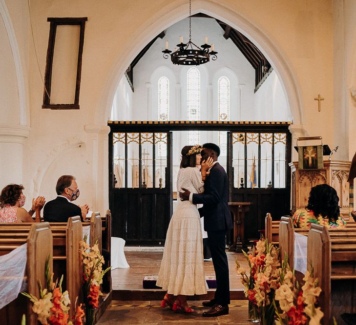 Church wedding ceremony with colourful gladiola pew end flowers 