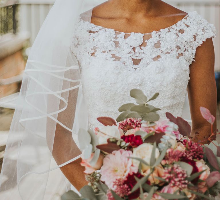 Black bride with classic bridal up do with front tendrils