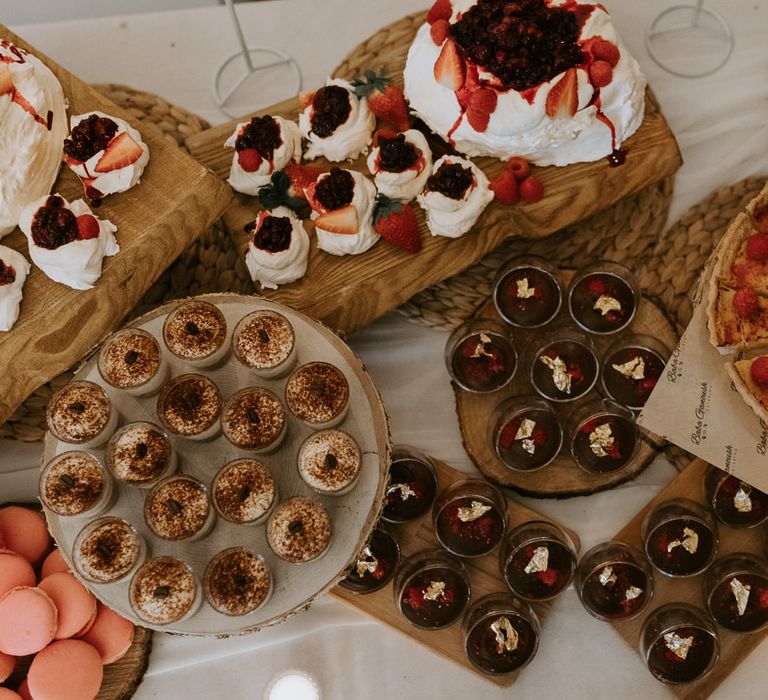 Wedding dessert table with chocolate, cakes, tarts, meringues and macarons