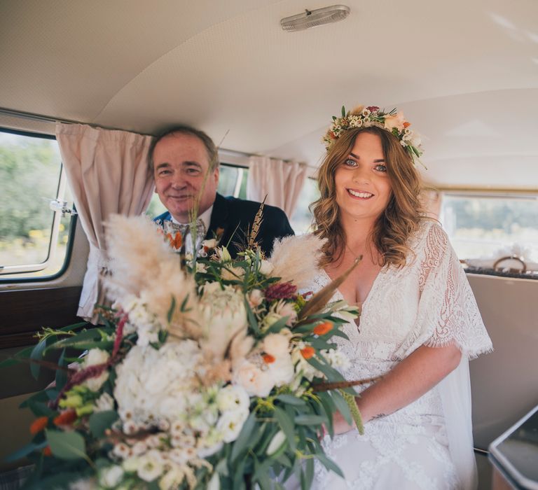 Bride sits in Vintage VW camper van on the day of her wedding