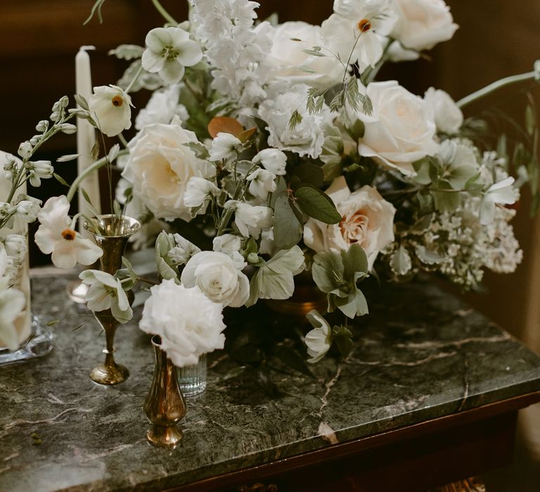 White floral decoration with green foliage 