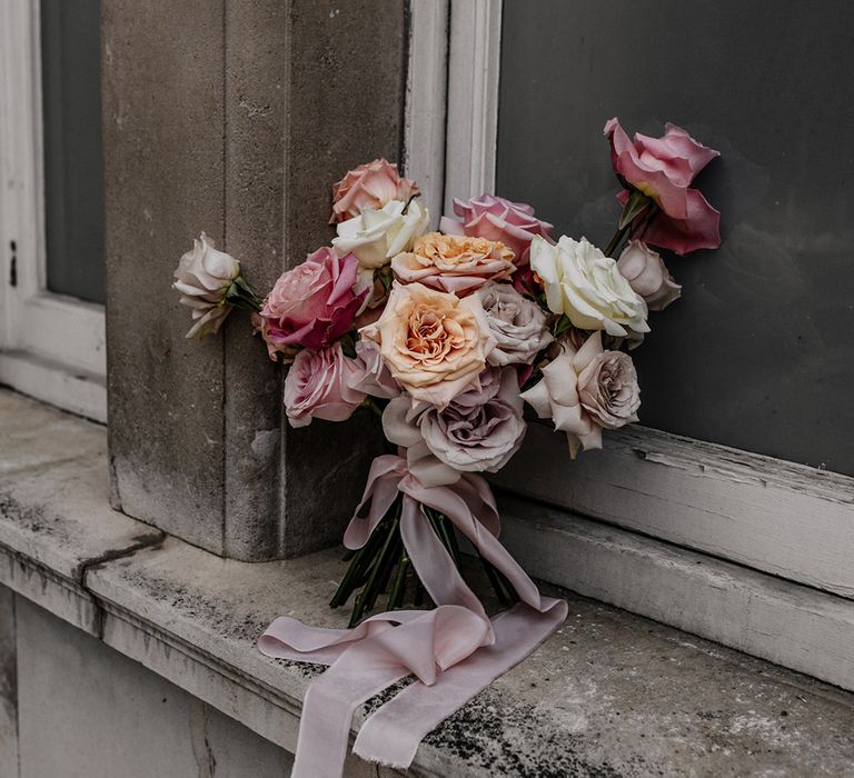 Romantic pink, peach, lilac and white peeled back rose wedding bouquet 