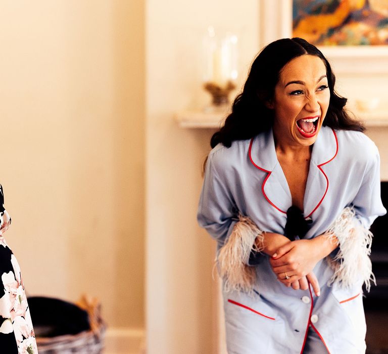 Excited bride in blue pyjamas during wedding preparations