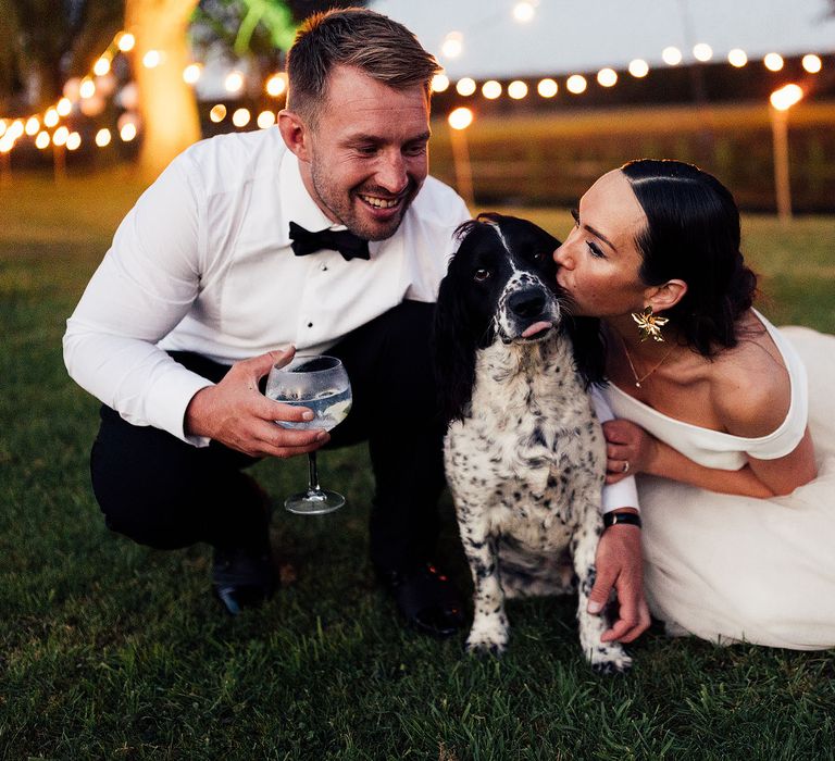 Bride and groom with their pet dog at the wedding