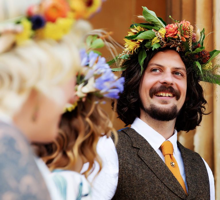 Groom smiles and laughs on his wedding day