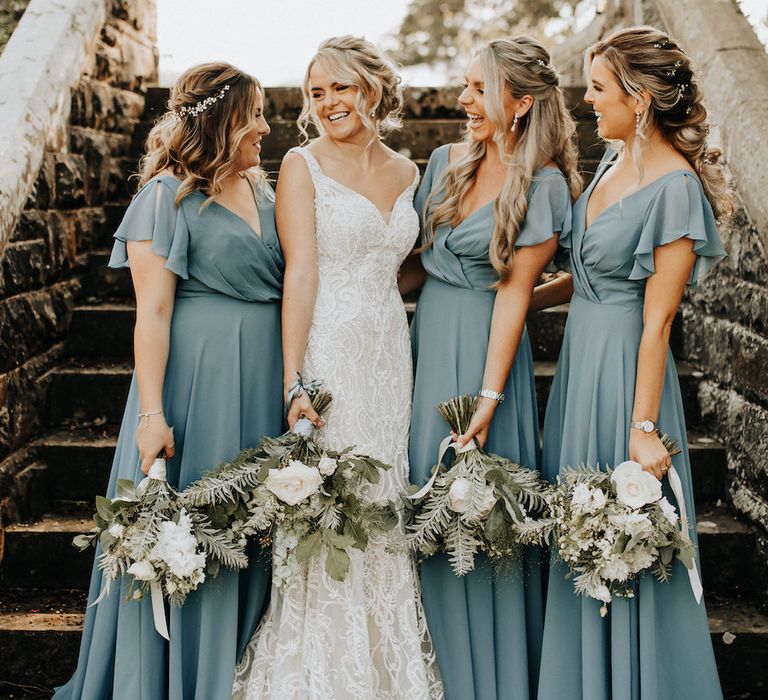 Blue bridesmaid dresses with white bouquets 