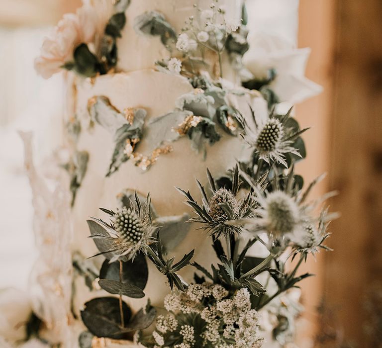 Amazing wedding cake with thistle and foliage decor