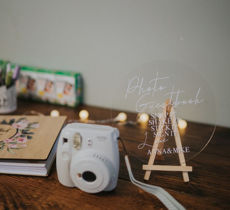 Polaroid wedding guestbook with acrylic sign