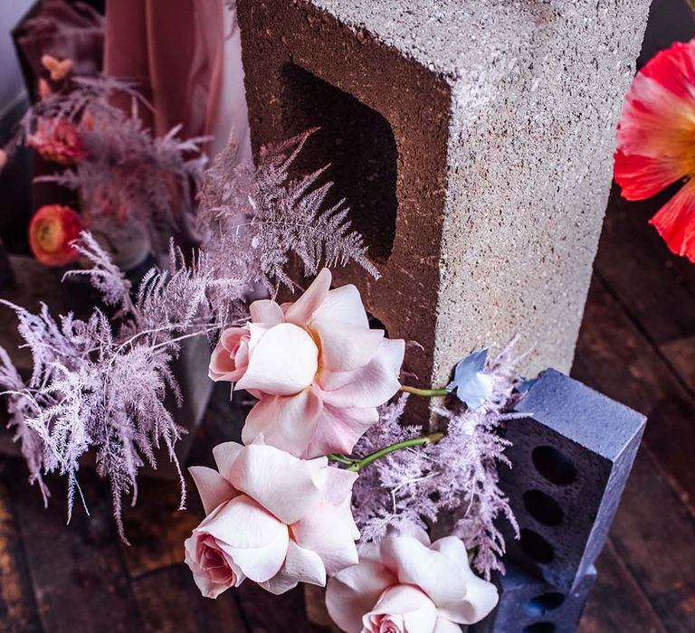 concrete plinths, disco balls and peeled back roses wedding decor 