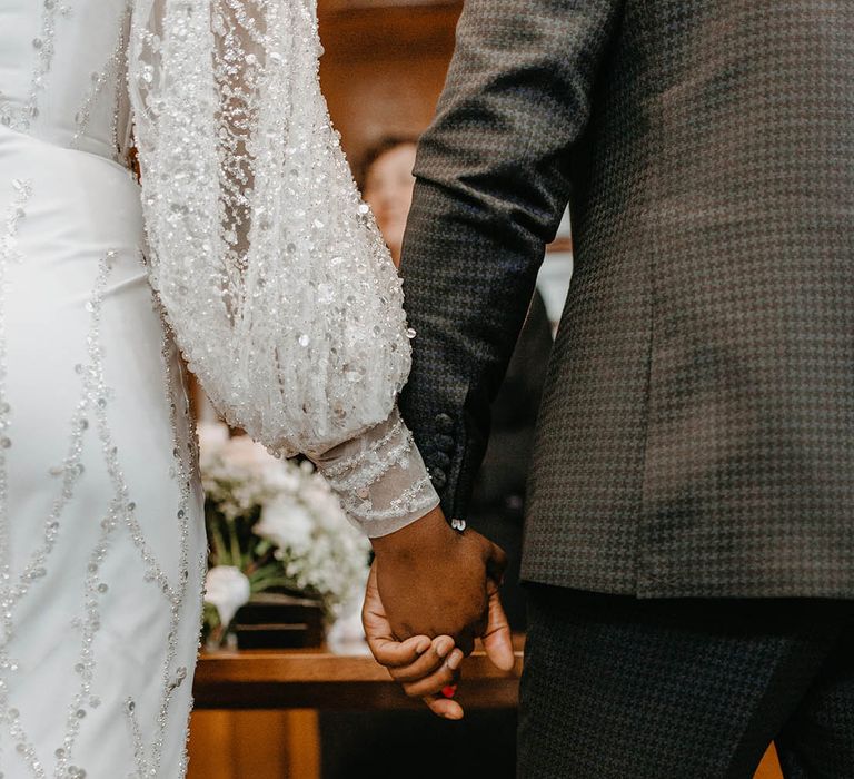 Bride hold hands with her groom on their wedding day