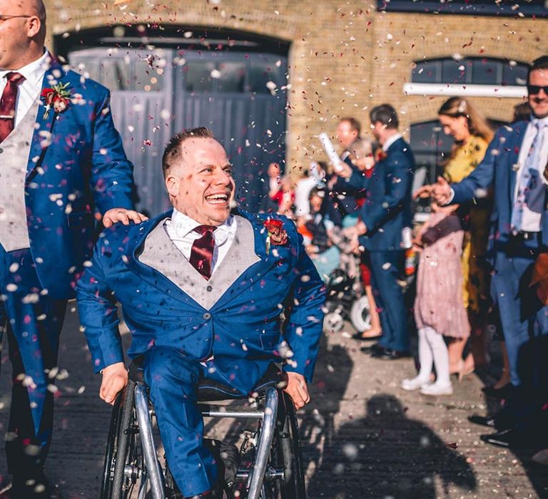 Confetti moment for grooms in custom-made blue wedding suits from Vietnam