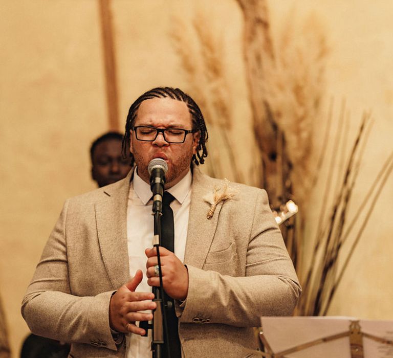 Groomsmen gives speech on wedding day during reception 