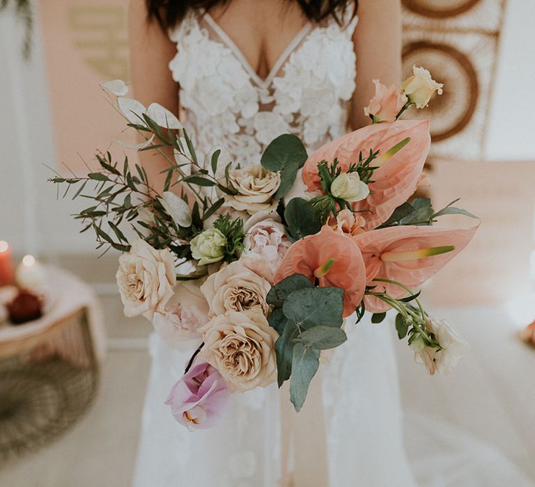 Wedding bouquet with peach and pink anthuriums, roses and orchids 