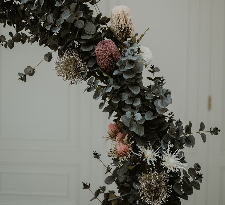 Floral archway complete with white and pink roses dotted throughout